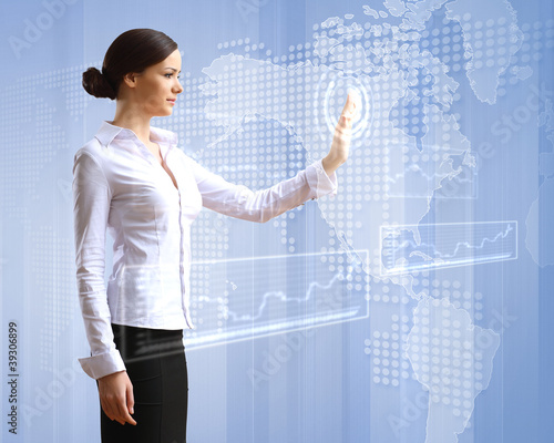 Photo: Business woman and touchscreen technology Business woman and touchscreen technology