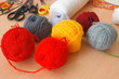 Colorful woolen yarns and scissors on the table