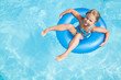 Swimming girl in blue water - space for text
