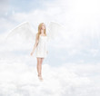 Angel standing in a clouds