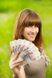 Photo: Young woman holding money Young woman holding money