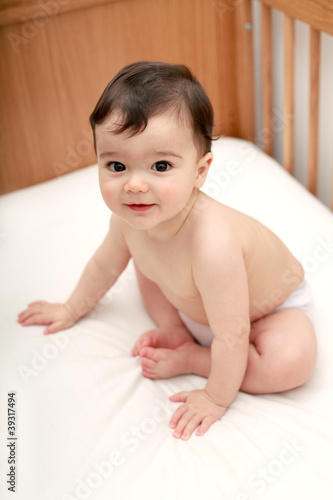 Photo: Beautiful baby sitting in cot Beautiful baby sitting in cot