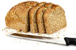 Photo: a loaf of bread with a three slices and a knife a loaf of bread with a three slices and a knife