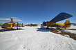 Old airplanes parked on a meadow with snow Old airplanes parked on a meadow with snow