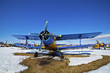 Old airplanes parked on a meadow with snow Old airplanes parked on a meadow with snow