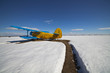 Old airplanes parked on a meadow with snow Old airplanes parked on a meadow with snow