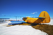 Old airplanes parked on a meadow with snow Old airplanes parked on a meadow with snow
