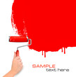 Hand with red roller painting the white wall Hand with red roller painting the white wall