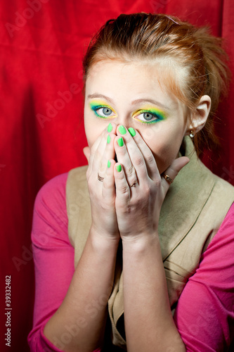 Photo: Sad redhead girl closed her mouth with hands Sad redhead girl closed her mouth with hands