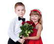 Girl and boy greeting with flowers isolated over white
