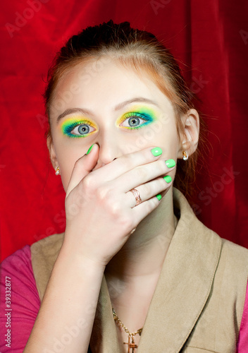 Photo: Sad redhead girl closed her mouth with hand Sad redhead girl closed her mouth with hand