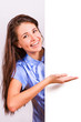 Photo: Attractive girl with braces presenting empty board Attractive girl with braces presenting empty board