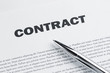 Contract and pen at the desk ready to sign it
