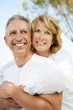 Mature couple smiling and embracing.