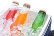 Closeup of three soda bottles in ice chest