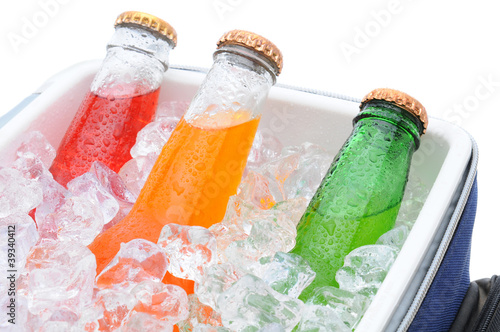 Photo: Closeup of three soda bottles in ice chest Closeup of three soda bottles in ice chest