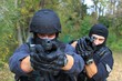 two armed policemen, aiming frontal view details