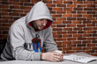 Photo: man in handcuffs at the table man in handcuffs at the table
