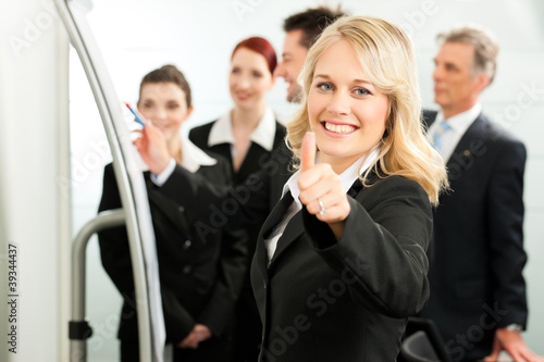 Photo: Business Team with leader in office Business Team with leader in office