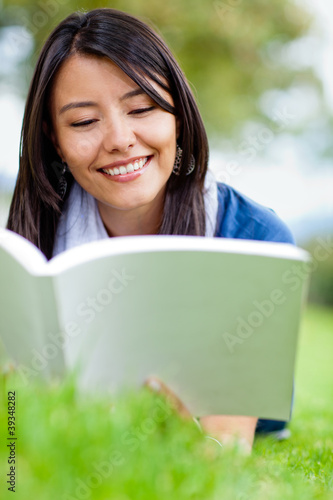 Photo: Girl reading outdoors Girl reading outdoors