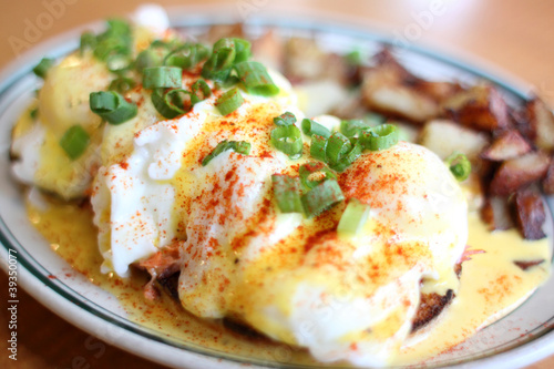 Photo: Eggs benedict with salmon and grilled potatoes. Eggs benedict with salmon and grilled potatoes.