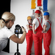 Photographer taking a picture of three painters at work