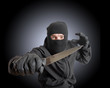 Masked criminal holding a knife Masked criminal holding a knife