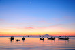 Golden sunset on a sea with silhouette of ships at Suratthani