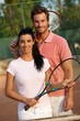 Smiling couple on tennis court Smiling couple on tennis court