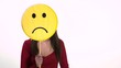 Sad young woman using emoticon for emotions