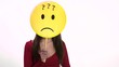 Confused young woman using emoticon for emotions
