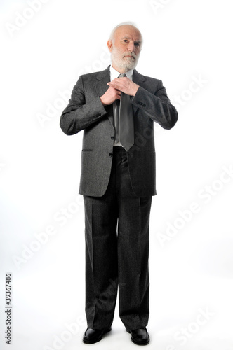 Photo: a man fixes his tie a man fixes his tie