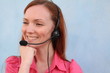 Redhead young woman at helpdesk center, smiling