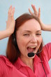 Redhead young woman with headset, shouting
