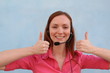 Woman with headset gesturing thumbs up