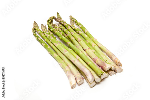 Photo: Asparagus isolated on a white studio background. Asparagus isolated on a white studio background.