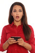 Portrait of young business woman surprised by text message
