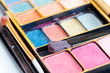 Multicolored eye shadows and cosmetics brush