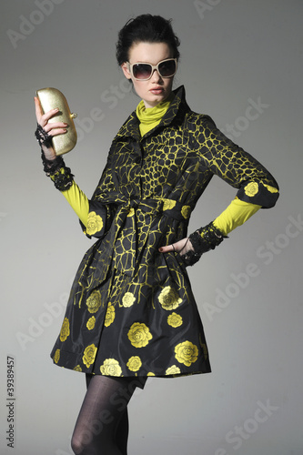 Photo: fashion model wearing sunglasses holding purse fashion model wearing sunglasses holding purse
