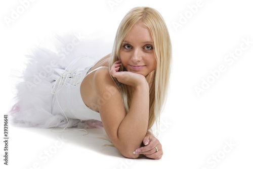 Photo: Portrait of beautiful blond young woman in white dress isolated Portrait of beautiful blond young woman in white dress isolated