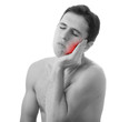 young man holding his aching tooth in pain, isolated on white ba