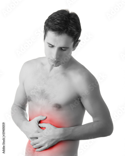 Photo: young man holding his sick stomach in pain, isolated on white ba young man holding his sick stomach in pain, isolated on white ba
