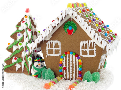 Photo: Gingerbread house and christmas tree on the white background Gingerbread house and christmas tree on the white background