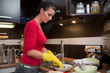 Young woman do the cleaning in kitchen