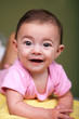 Beautiful baby girl on green background