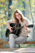 Photo: Young girl guitar player in forest Young girl guitar player in forest