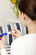 Foto: Bruenette woman with pregnancy test at home Bruenette woman with pregnancy test at home