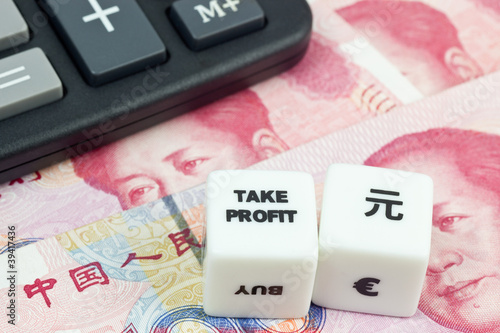 Photo: Chinese currency with calculator and dice showing TAKE PROFIT Chinese currency with calculator and dice showing TAKE PROFIT