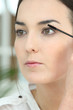 Woman applying mascara