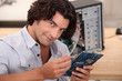 mid long hair man is repairing a computer